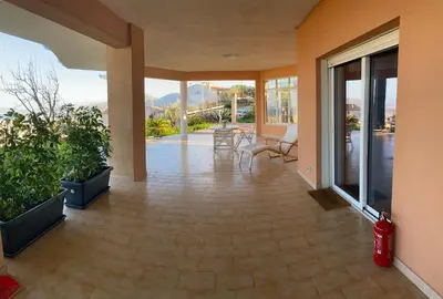 a living room with a patio with chairs and windows at La Casa dell'Aviatore in Boccadifalco