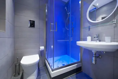a bathroom with a shower and a toilet and a sink at Room & Breakfast Zero in Palermo