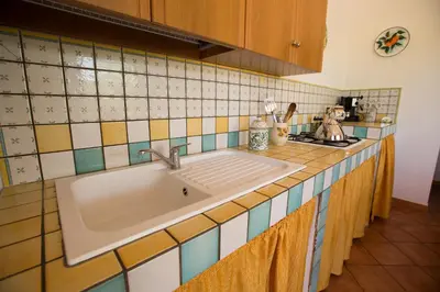 a kitchen counter with a sink in a kitchen at Villa Chiara in Scopello