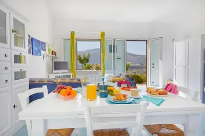 a white table with food on it in a living room at Villa Del Sol - Scopello-Villas in Scopello