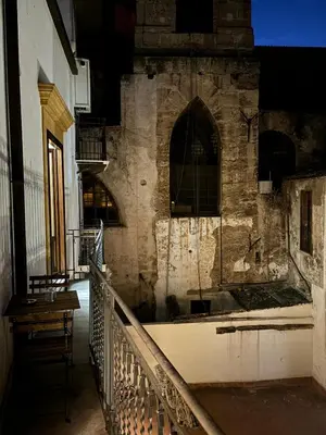 a hallway of an old building with a staircase at Vittorio Emanuele Suite Apartment in Palermo