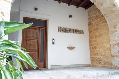 an entrance to a house with a wooden door at Vittorio Emanuele Suite Apartment in Palermo