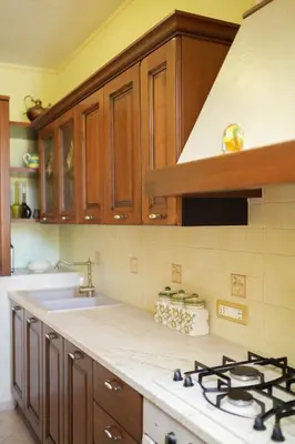 two pictures of a kitchen with cabinets and a sink at O Cannulicchiu in Altofonte