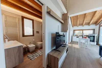 a bathroom with a sink and a tv in a room at Villa Michela - Dimora di Charme a Cefalù con panorama sul mare by CEFALU BIZ in Cefalù