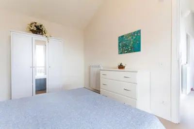 a white bedroom with a bed and a dresser at Villa dell'Ulivo - by DomuSicily in Terrasini