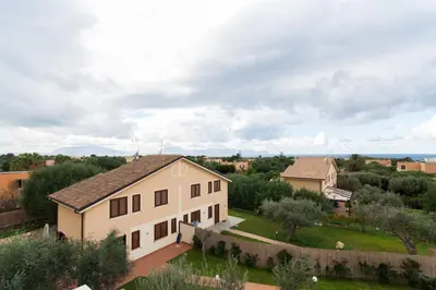 an aerial view of a white house with a yard at Villa dell'Ulivo - by DomuSicily in Terrasini