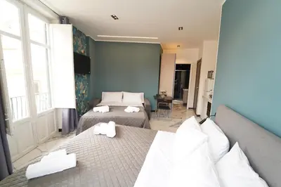 a bedroom with two beds and a window at Appartamento Ottanio- Quattro Canti 200 mt in Palermo