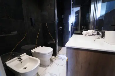 a bathroom with a toilet and a sink and a shower at Appartamento Ottanio- Quattro Canti 200 mt in Palermo