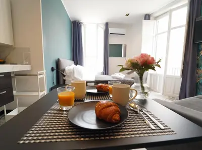 a table with a plate of croissants and orange juice at Appartamento Ottanio- Quattro Canti 200 mt in Palermo