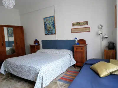 a bedroom with two beds and a blue bedspread at Appartamento Blu in Palermo