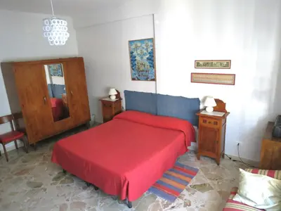 a bedroom with a red bed with a red blanket at Appartamento Blu in Palermo
