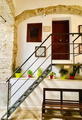 a staircase with potted plants in a building at Biscottari's home in Palermo