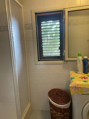 a bathroom with a window and a sink and a toilet at Villetta 200mt mare e piscina in Campofelice di Roccella