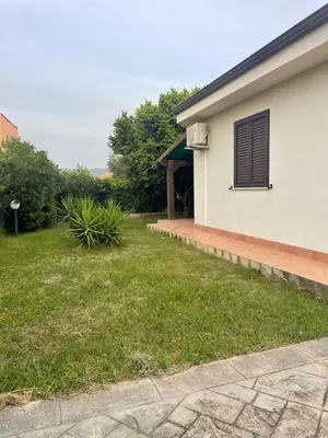 a house with a window on the side of it at Villetta 200mt mare e piscina in Campofelice di Roccella