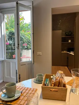a table with a wooden box of bagels and cups at YourLife Suite1 - Deliziosa casa con terrazzino in Palermo