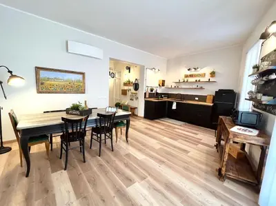 a dining room and living room with a table and chairs at Civico 88 in Calatafimi