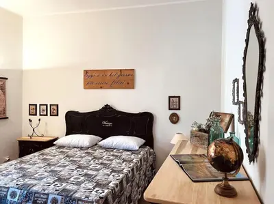 a bedroom with a bed and a wooden table at Civico 88 in Calatafimi