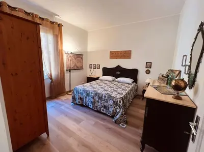 a bedroom with a bed and a table and a door at Civico 88 in Calatafimi
