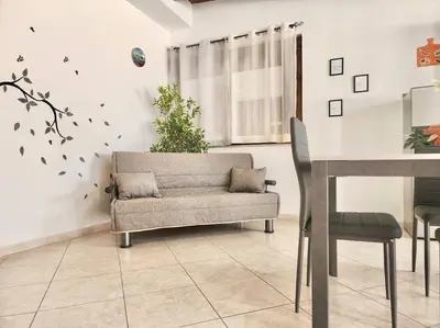 a living room with a couch and a table at Bay View Wi-Fi-Vista Mare-Free Parking in Carini