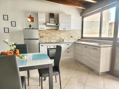 a kitchen with a table and a dining room at Bay View Wi-Fi-Vista Mare-Free Parking in Carini