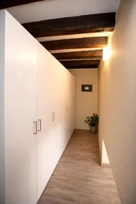 a kitchen with a table and chairs in a room at Le Quattro Stagioni - Apartments in Palermo