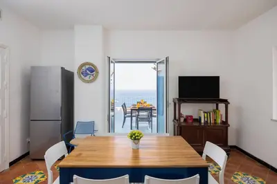 a dining room with a table and a view of the ocean at Terrazza sul mare in Santa Flavia