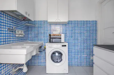 a bathroom with a washing machine and a sink at Terrazza sul mare in Santa Flavia