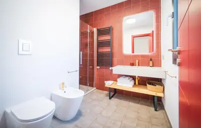 a bathroom with a white toilet and a sink at Dimora Harmonia in Carini