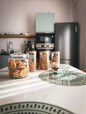 a kitchen counter with glass jars of nuts and cookies at Dimora Harmonia in Carini