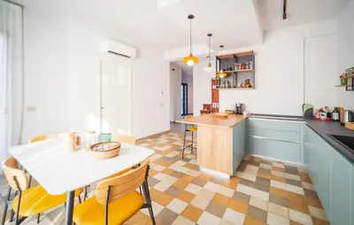 a kitchen with a table and chairs in a room at Dimora Harmonia in Carini