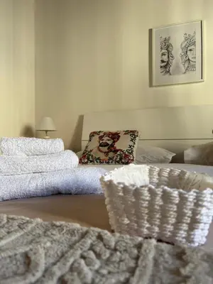 a bedroom with a mirror and a bed with towels at Moro House in Sferracavallo