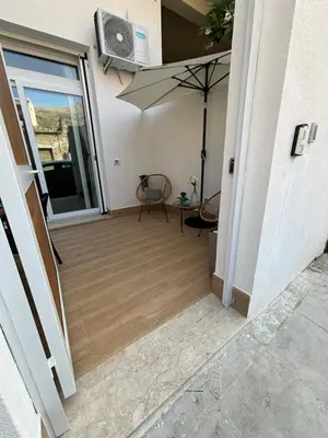 a kitchen table with two chairs and a white counter top at Loft Sferra d aMare in Sferracavallo