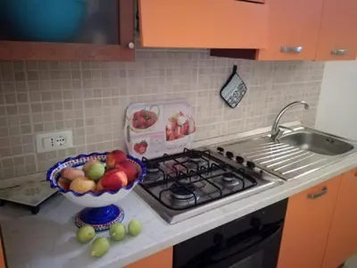 a kitchen counter with a bowl of fruit and a sink at Casa il Sole Casevacanze Ferienwohnung Daniele Furco in Castellammare del Golfo