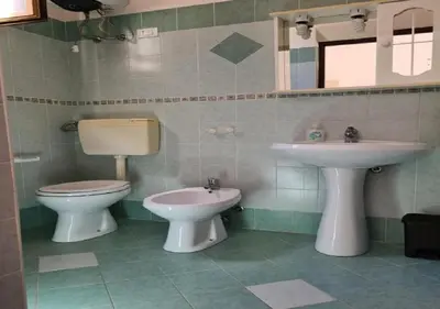 a bathroom with a toilet and a sink at Casa il Sole Casevacanze Ferienwohnung Daniele Furco in Castellammare del Golfo