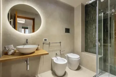 a bathroom with a sink and a toilet and a mirror at Prospettiva Ballarò - Sopra il mercato in Palermo