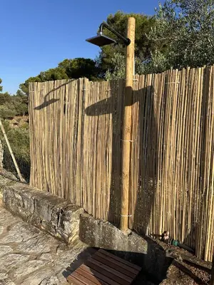 a wooden fence with a street sign on top of it at Cocciu D'amuri Home - Scopello in Scopello