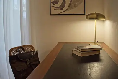 a table with a lamp and two books on it at Porto Felice Home Palermo in Palermo
