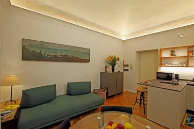 a living room with a couch and a table at Porto Felice Home Palermo in Palermo