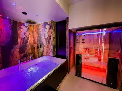 a bathroom with a tub and a shower with purple lighting at SUPREME Suite&Spa in Palermo