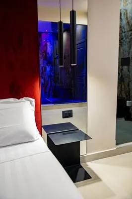 a bedroom with a bed and a window at SUPREME Suite&Spa in Palermo