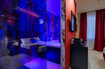 a bathroom with a sink and a bed in a room at SUPREME Suite&Spa in Palermo
