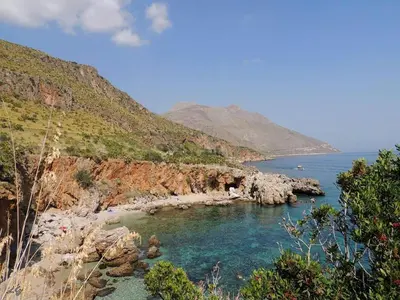 a view of a beach with rocks and water at Blunda Holiday Home in Castellammare del Golfo