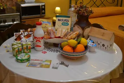 a table with a bowl of fruit and other food on it at B&B Jolly house Bolognetta in Bolognetta
