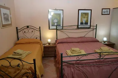 a bedroom with two beds and two mirrors at B&B Jolly house Bolognetta in Bolognetta