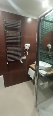 a bathroom with a toilet and a glass door at Casa di Lele in Carini