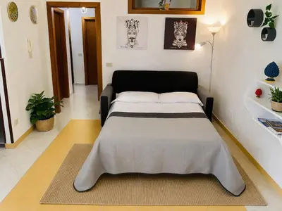 two beds in a hospital room with a clock on the wall at Casa Noce in Palermo