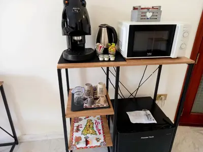 a shelf with a microwave and a coffee maker on it at Palermo dream Rooms in Palermo