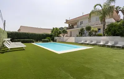 a yard with a swimming pool and chairs and a house at Villa Dwellings With Pool For Exclusive Use in Alcamo
