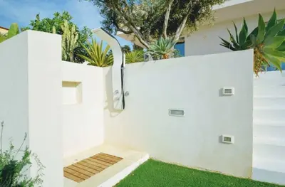 a white fence with green grass in front of a house at Villa Dwellings With Pool For Exclusive Use in Alcamo