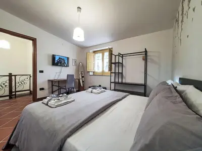 a bedroom with a bed and a table and a window at Holiday Home Maya's Home Palermo by Interhome in Palermo